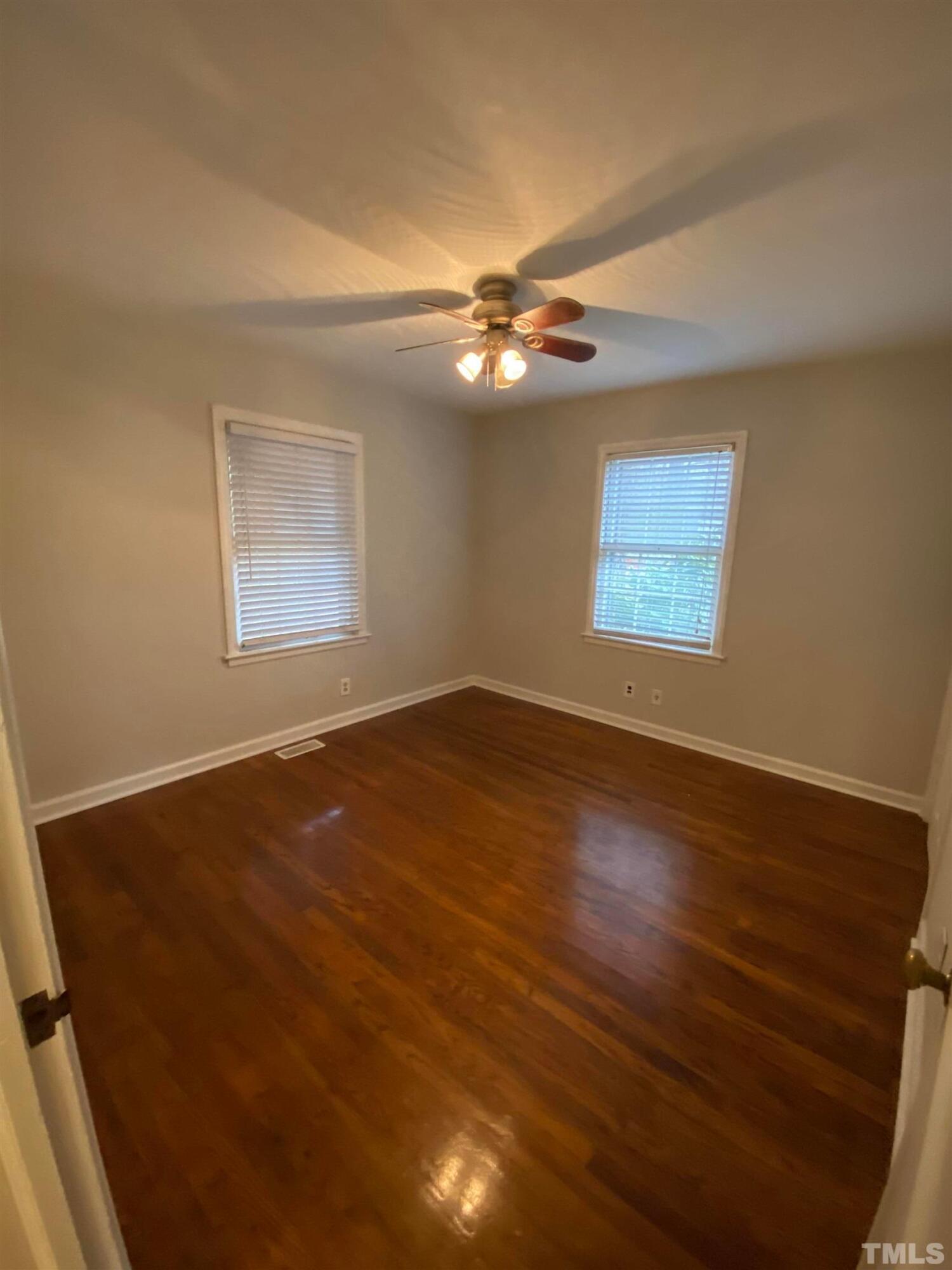 2418 Stevens Road Raleigh, NC 27610 - Photo 17 of 17 a view of empty room with wooden floor and fan
