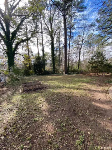 a view of a field with trees in the background