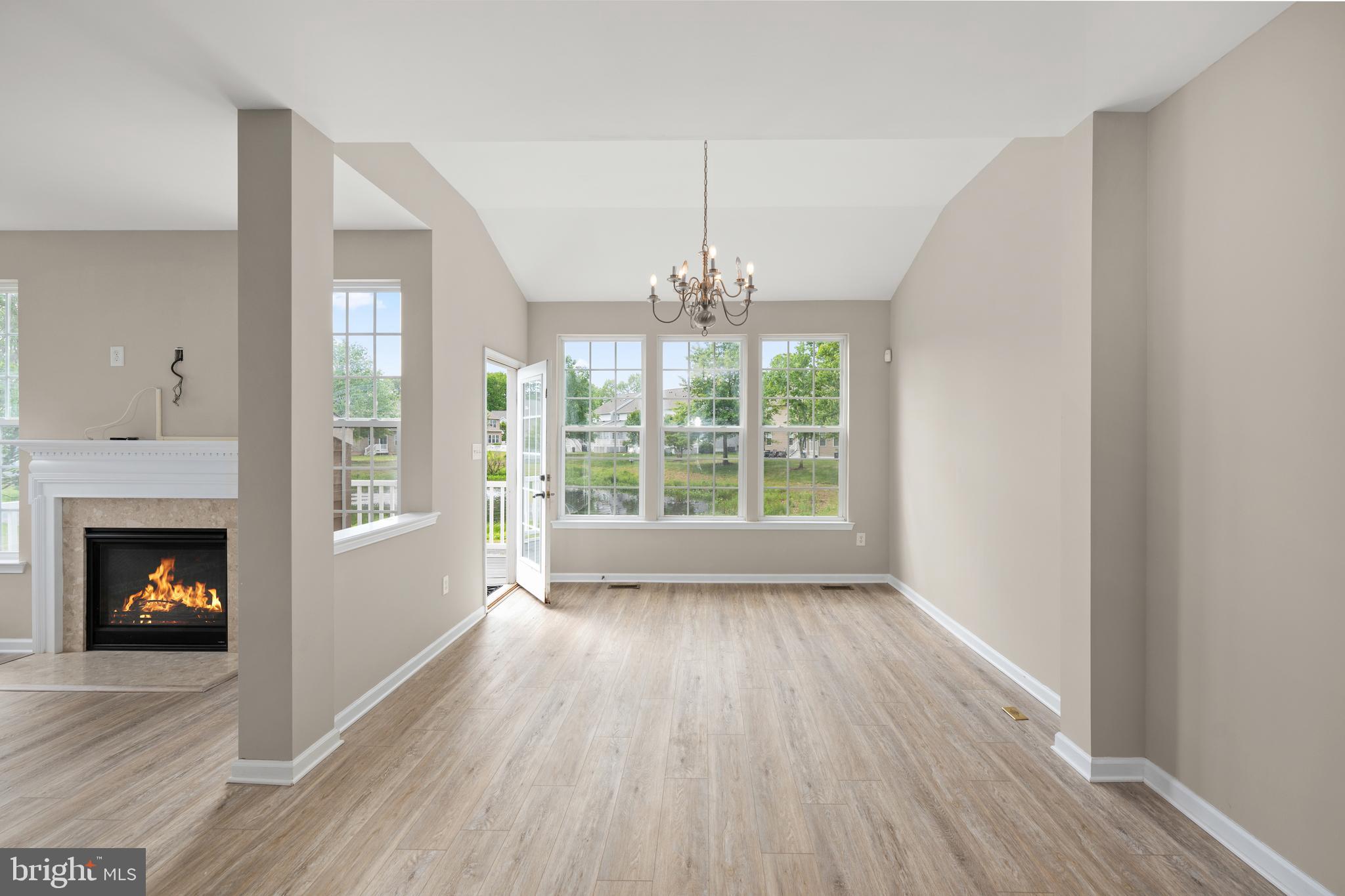 10023 Iron Pointe Drive Extension, Unit 201B2 Millsboro, DE 19966 - Photo 12 of 41 a view of an empty room with wooden floor and a window