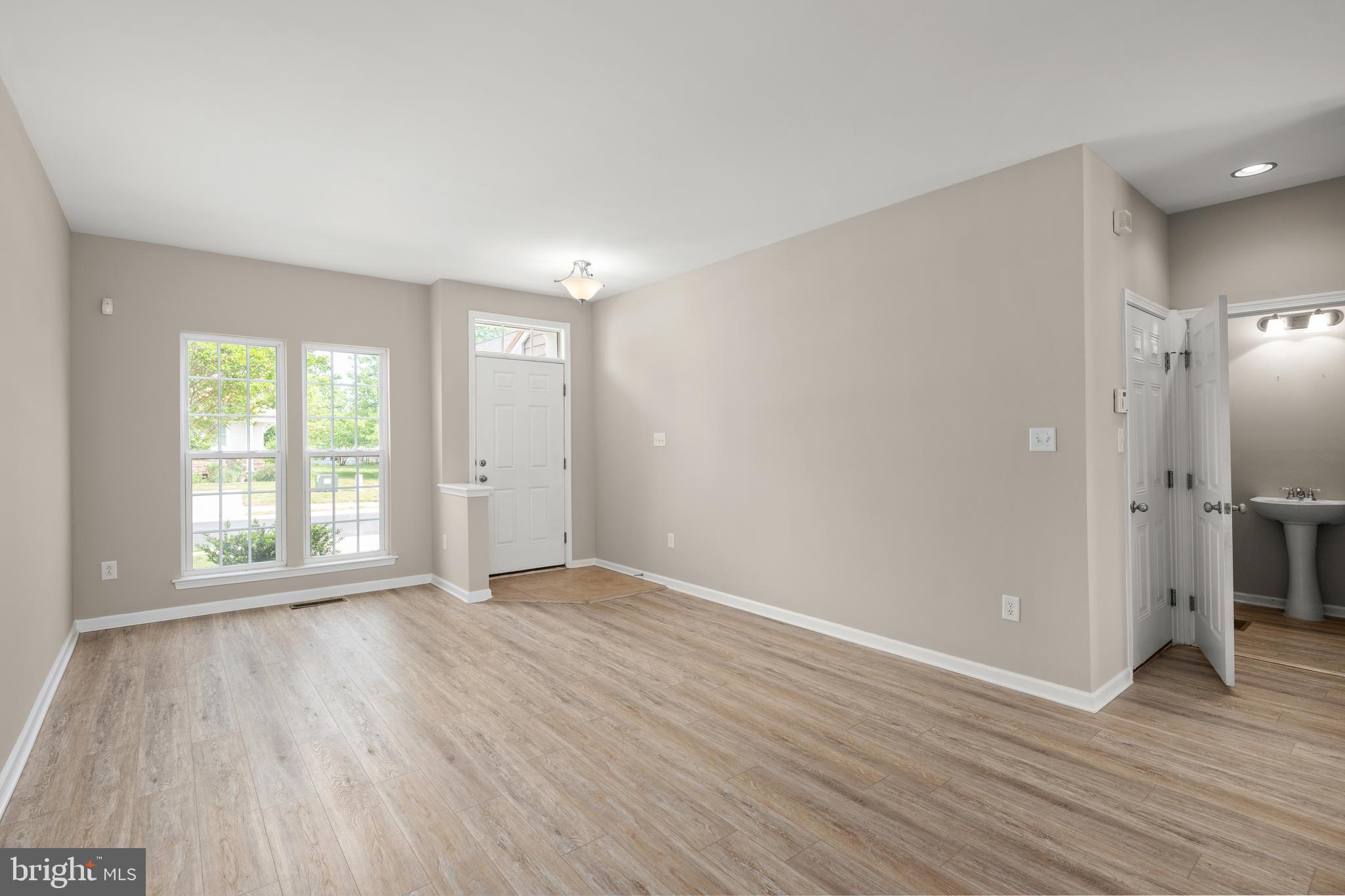 10023 Iron Pointe Drive Extension, Unit 201B2 Millsboro, DE 19966 - Photo 15 of 41 a view of an empty room with wooden floor and a window