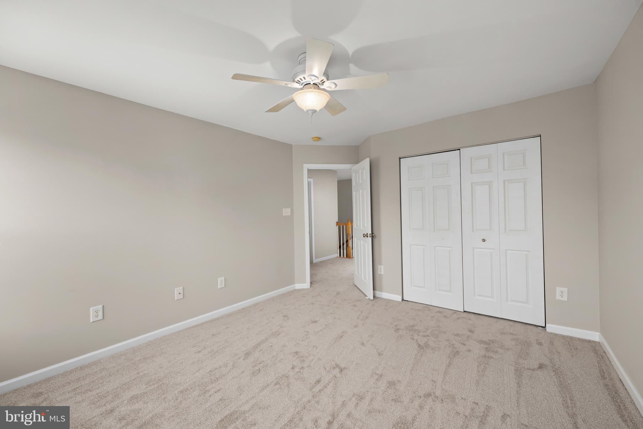 10023 Iron Pointe Drive Extension, Unit 201B2 Millsboro, DE 19966 - Photo 24 of 41 a view of an empty room with a chandelier fan