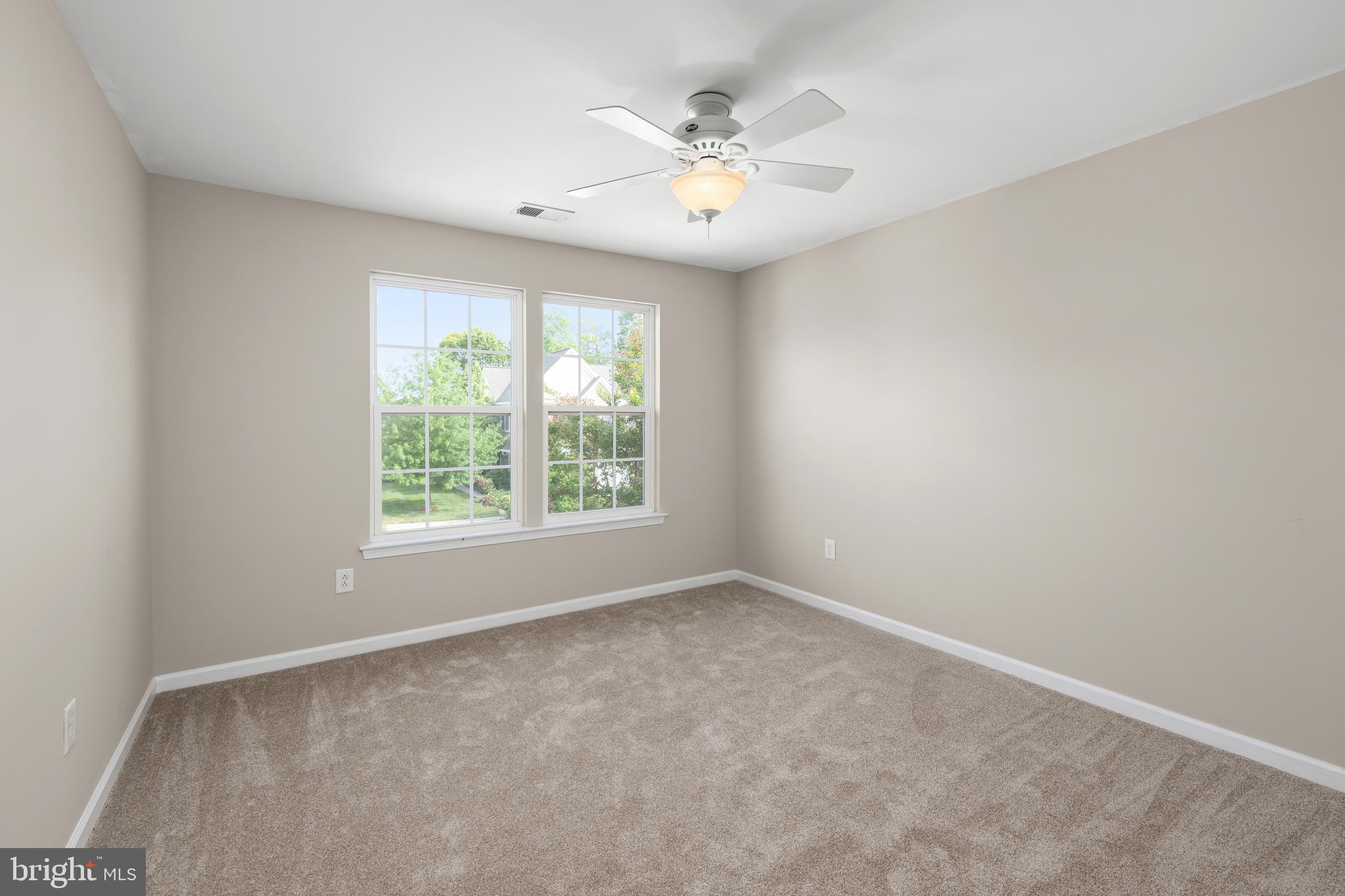 10023 Iron Pointe Drive Extension, Unit 201B2 Millsboro, DE 19966 - Photo 26 of 41 an empty room with windows and chandelier fan