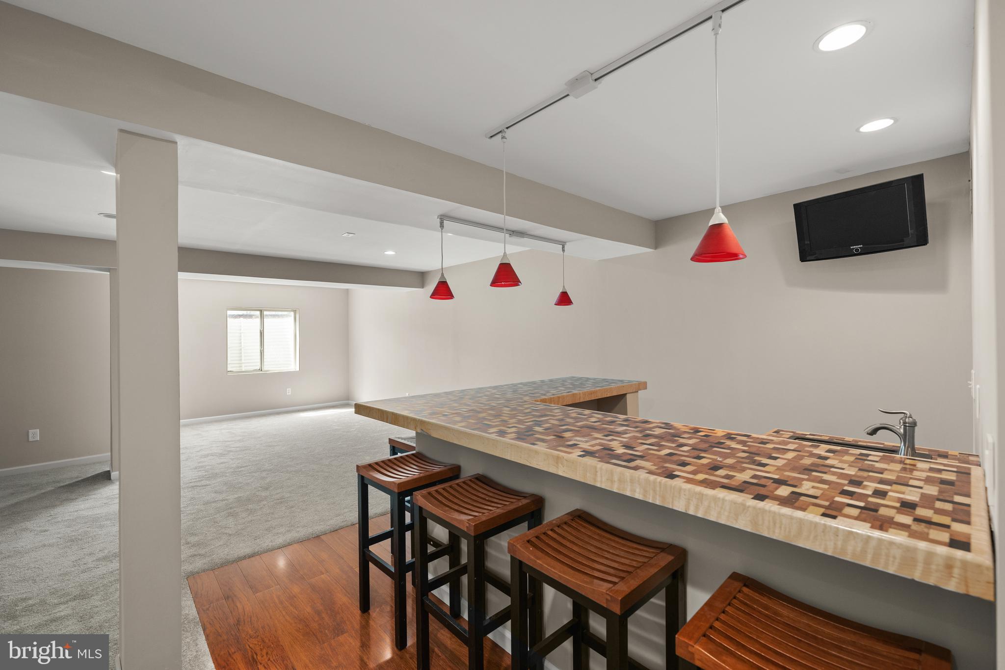 10023 Iron Pointe Drive Extension, Unit 201B2 Millsboro, DE 19966 - Photo 30 of 41 a view of kitchen island with furniture and flat screen tv