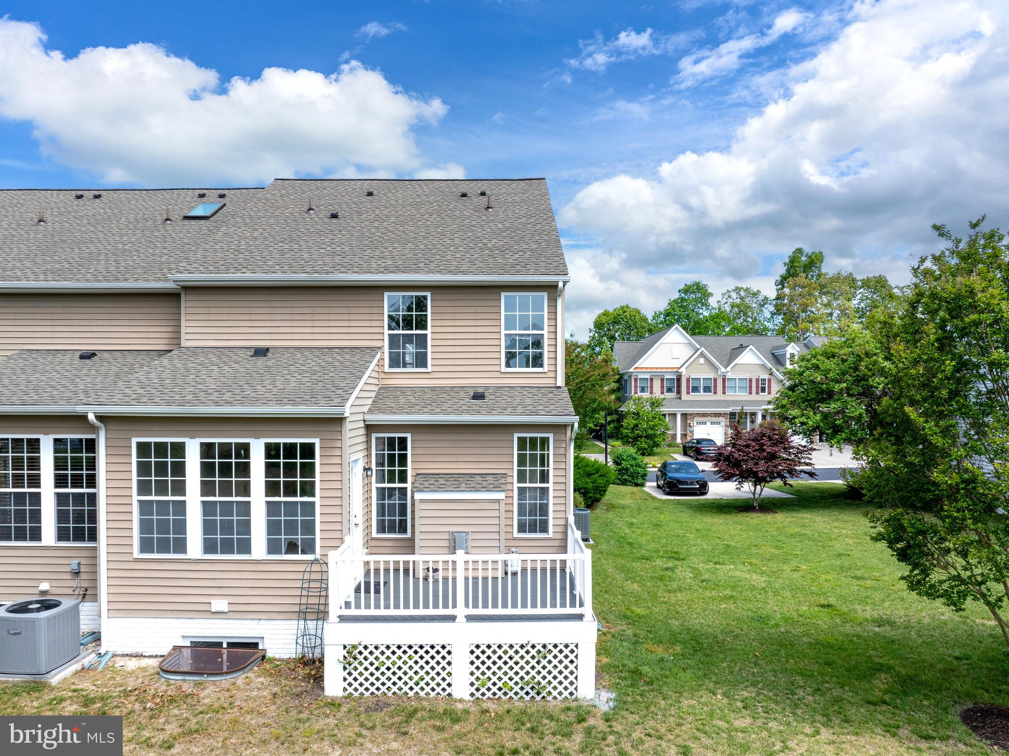 10023 Iron Pointe Drive Extension, Unit 201B2 Millsboro, DE 19966 - Photo 36 of 41 a front view of a house with a garden and deck
