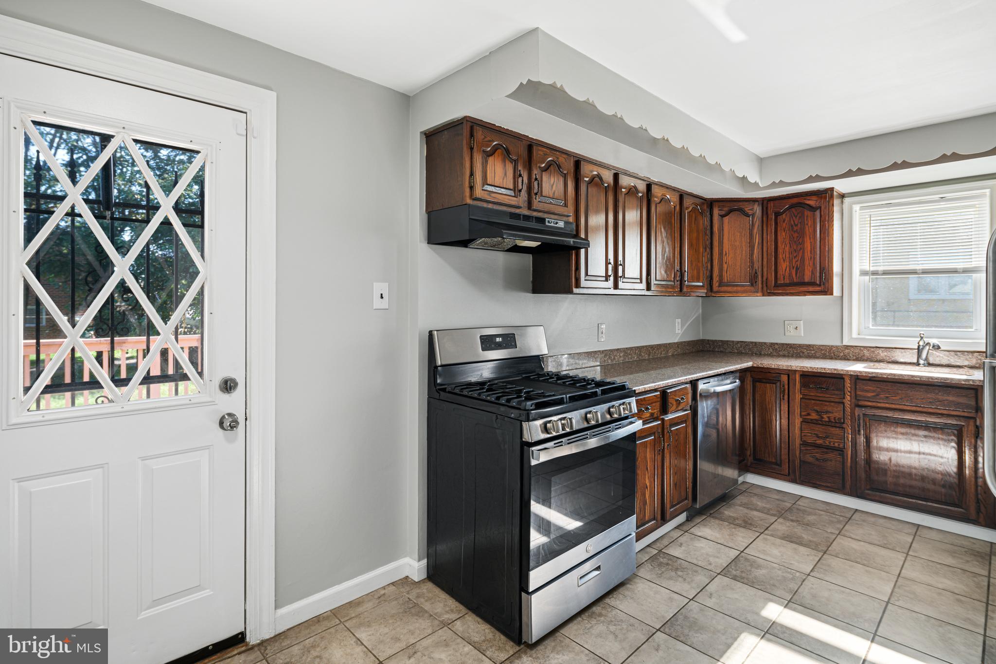 1625 Rhawn Street Philadelphia, PA 19111 - Photo 3 of 15 a kitchen with stainless steel appliances granite countertop a stove and a sink