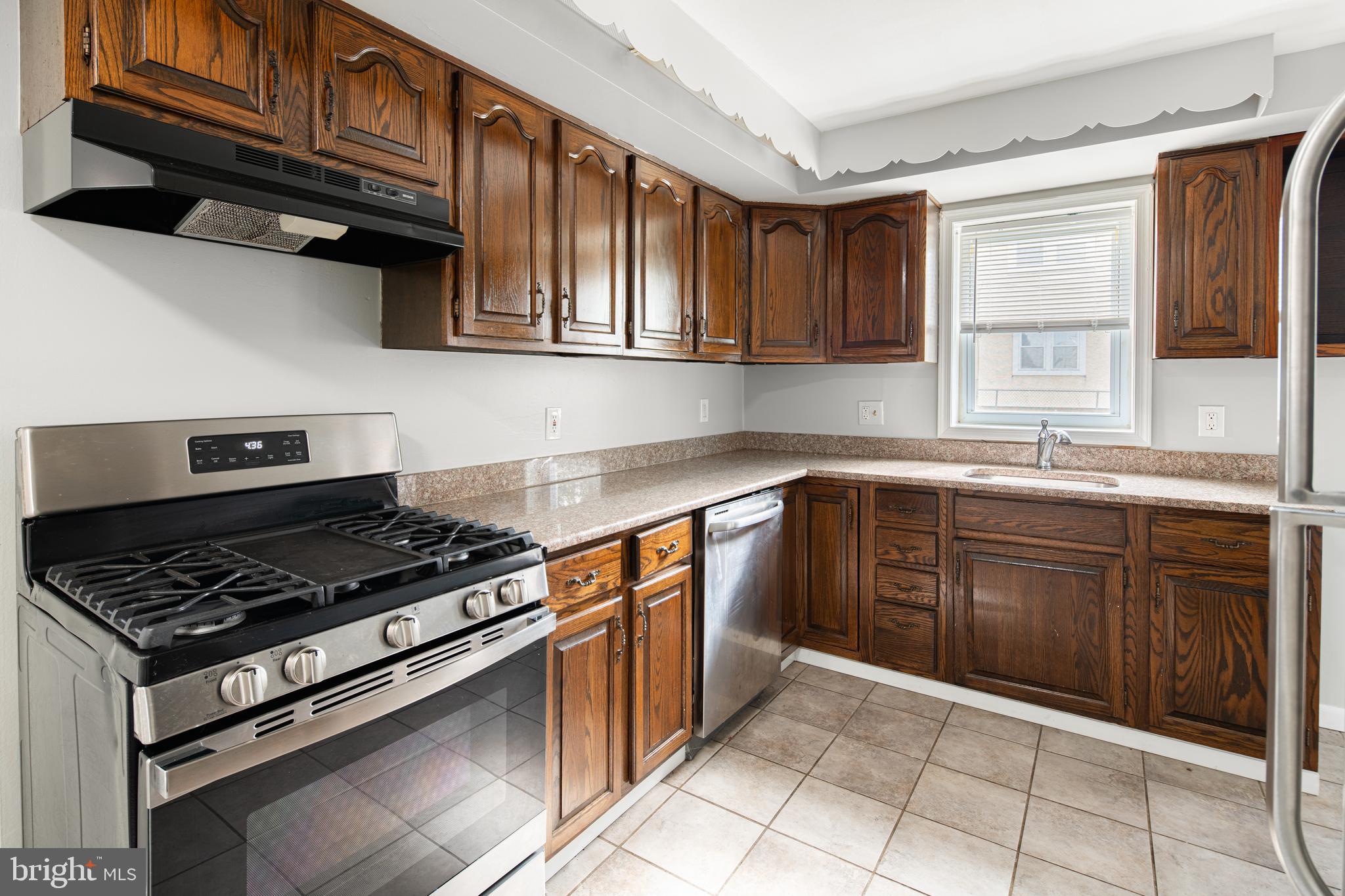 1625 Rhawn Street Philadelphia, PA 19111 - Photo 5 of 15 a kitchen with stainless steel appliances granite countertop a stove a sink and a microwave