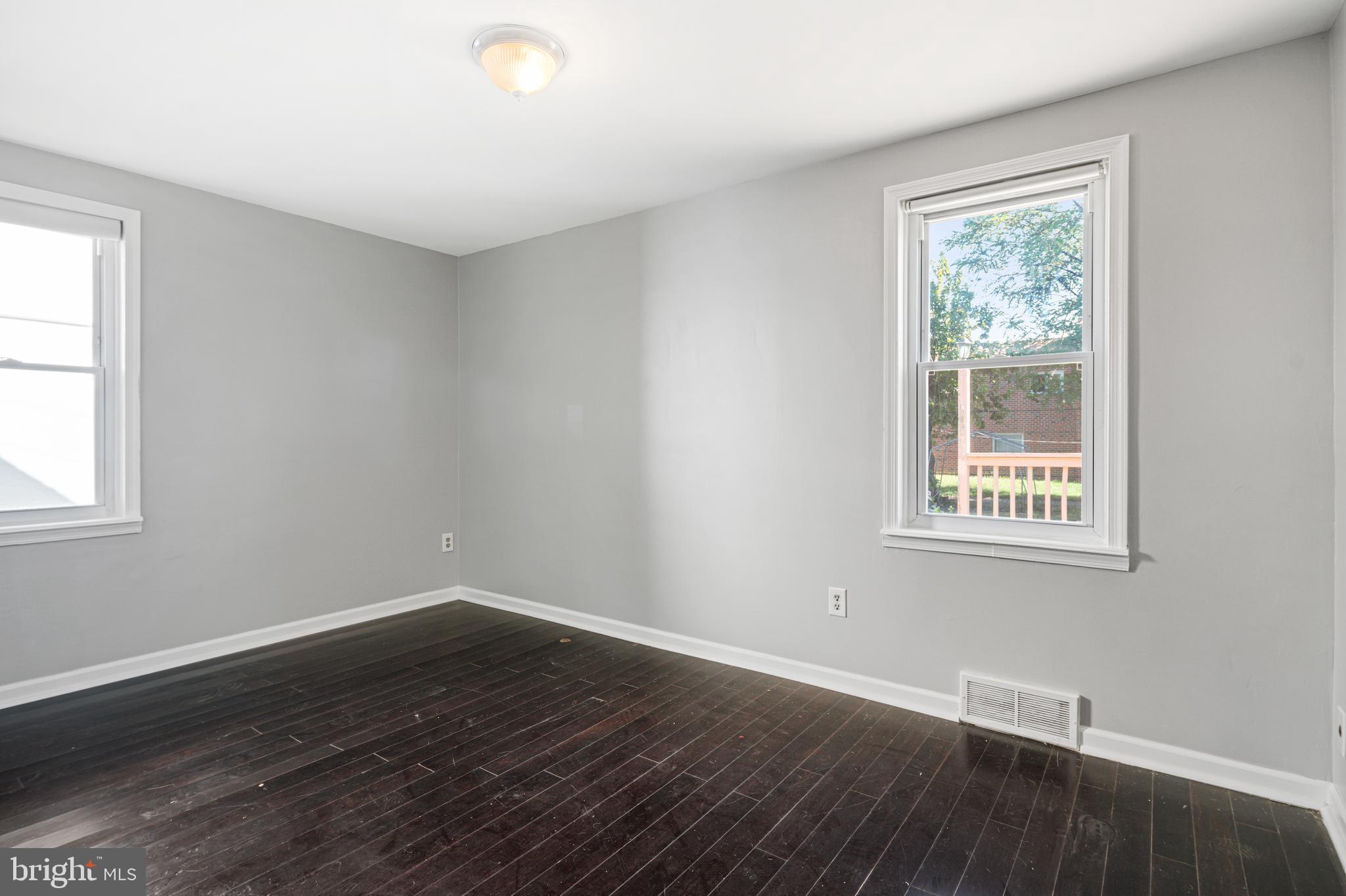 1625 Rhawn Street Philadelphia, PA 19111 - Photo 7 of 15 a view of an empty room with wooden floor and a window