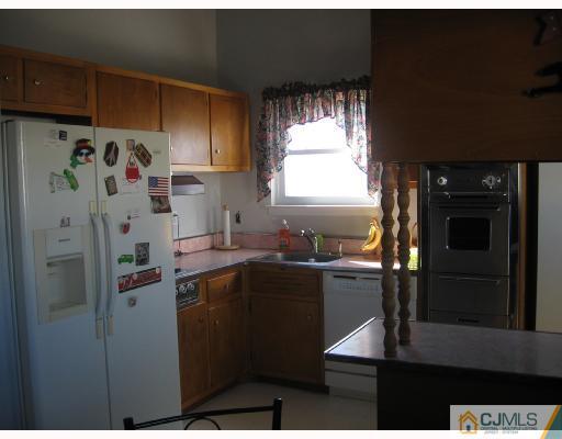 50 Eardley Road Edison, NJ 08817 - Photo 3 of 8 a kitchen with a refrigerator and a stove