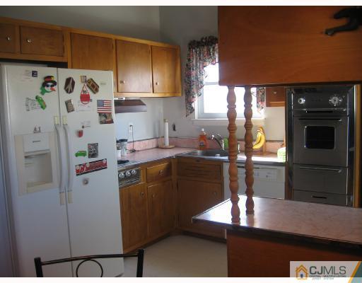 50 Eardley Road Edison, NJ 08817 - Photo 5 of 8 a kitchen with refrigerator and window