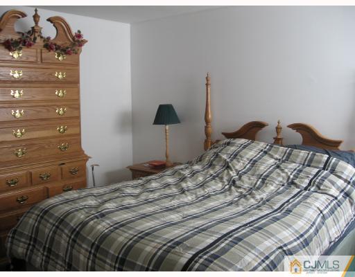 50 Eardley Road Edison, NJ 08817 - Photo 7 of 8 a bedroom with a bed and a closet