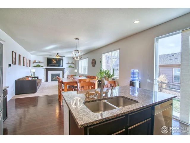 a kitchen with granite countertop a sink and a refrigerator