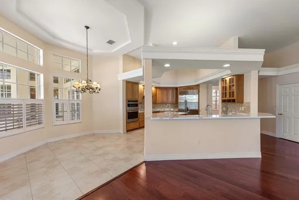 a view of kitchen with sink and refrigerator