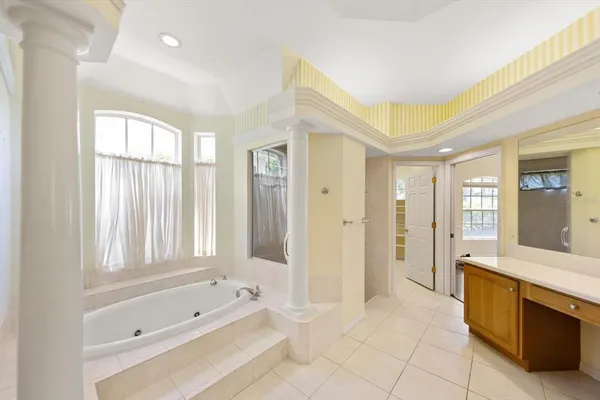a spacious bathroom with a tub shower and sink