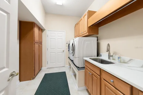 a kitchen with refrigerator and sink
