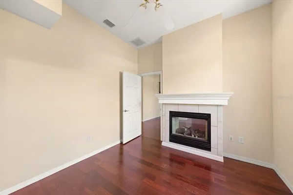 a room with a fireplace and wooden floor