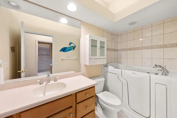 a bathroom with a sink a toilet and a mirror