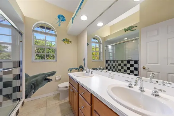 a bathroom with a double vanity sink and a mirror