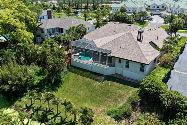 an aerial view of residential houses with yard