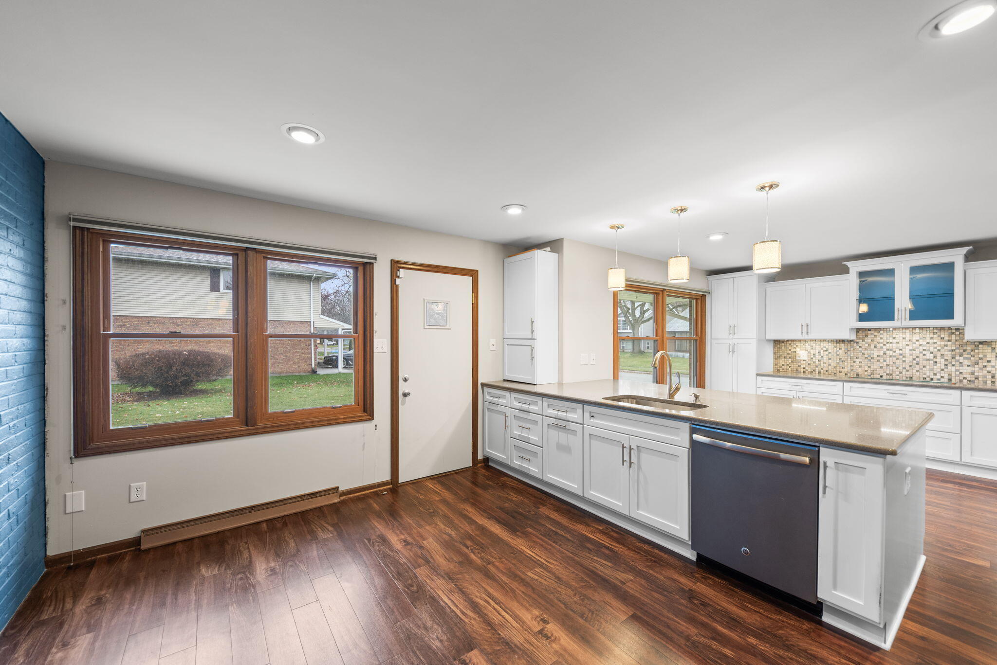 2595 West 65th Avenue Merrillville, IN 46410 - Photo 16 of 36 a large kitchen with stainless steel appliances granite countertop a large window a sink and cabinets