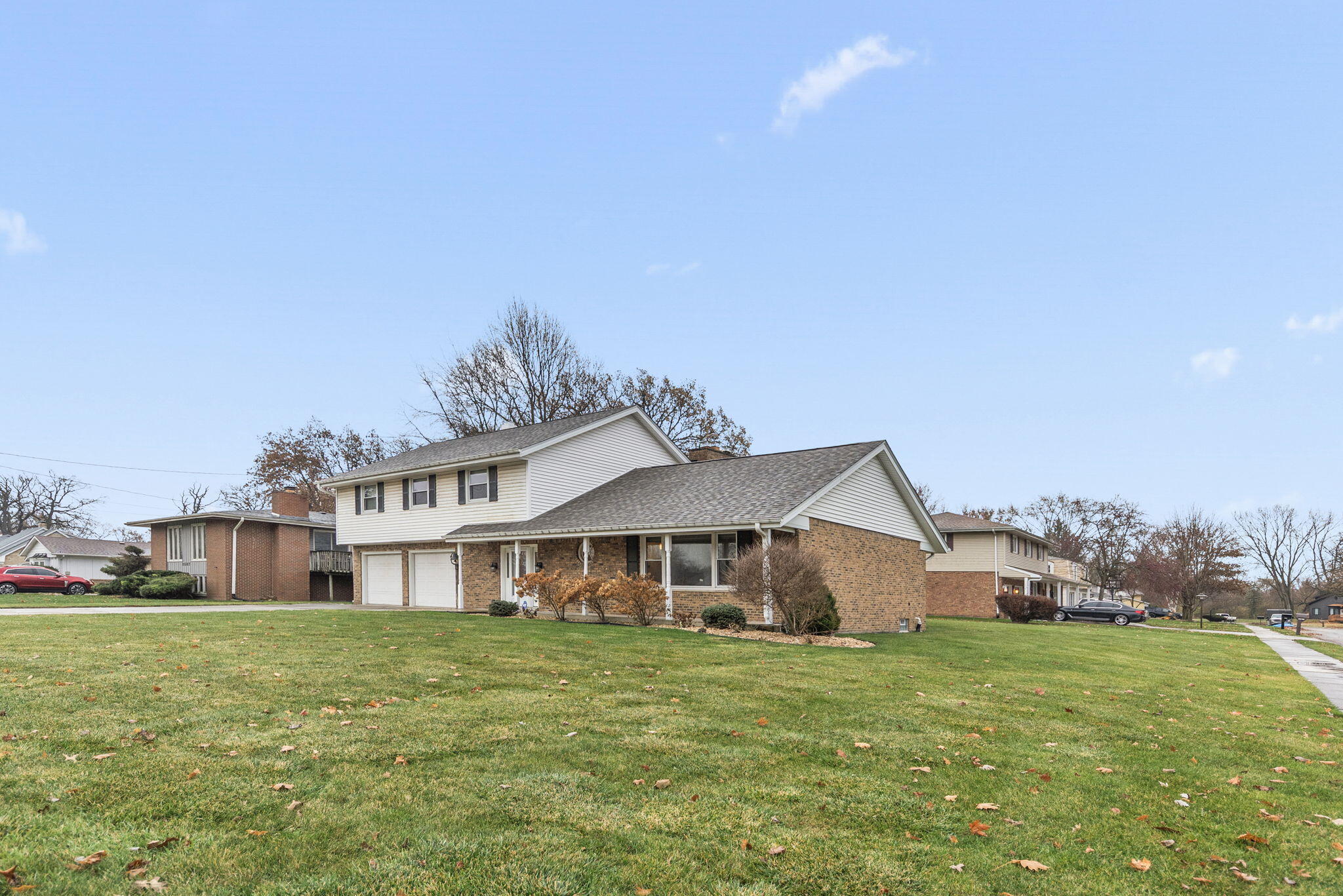 2595 West 65th Avenue Merrillville, IN 46410 - Photo 2 of 36 a front view of a house with garden