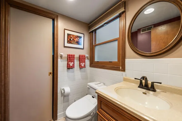 a bathroom with a toilet sink and mirror