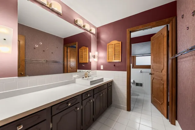 a spacious bathroom with a double vanity sink and a mirror
