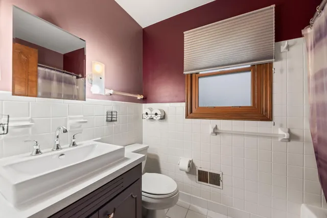 a bathroom with a sink a toilet and mirror