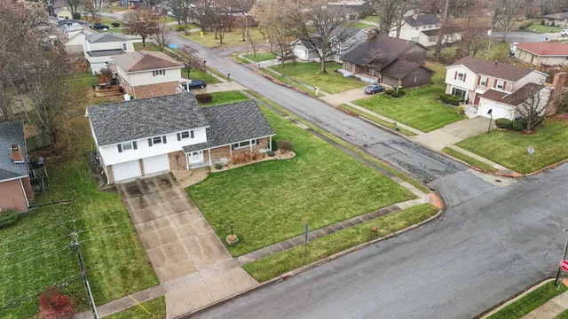 an aerial view of a residential houses with outdoor space and street view