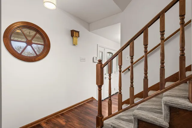 a view of staircase with wooden floor and a window