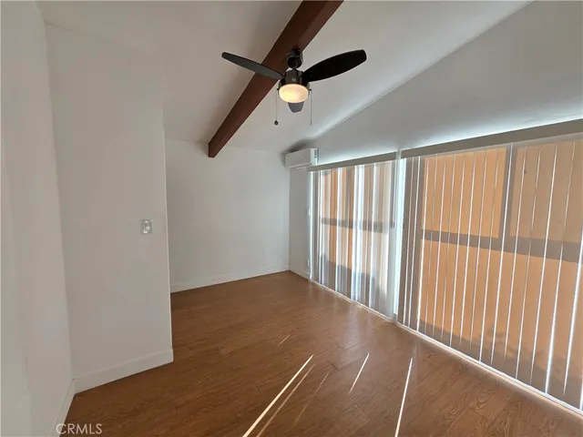 a view of a room with a ceiling fan