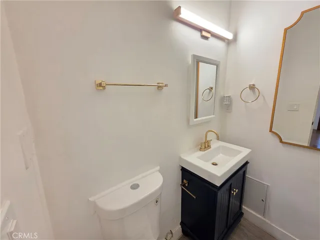 a bathroom with a sink a toilet and mirror