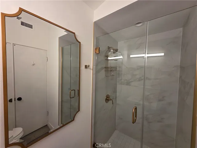 a bathroom with a shower and a sink