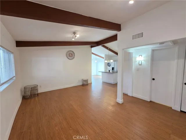 a view of a livingroom with wooden floor and a cabinet