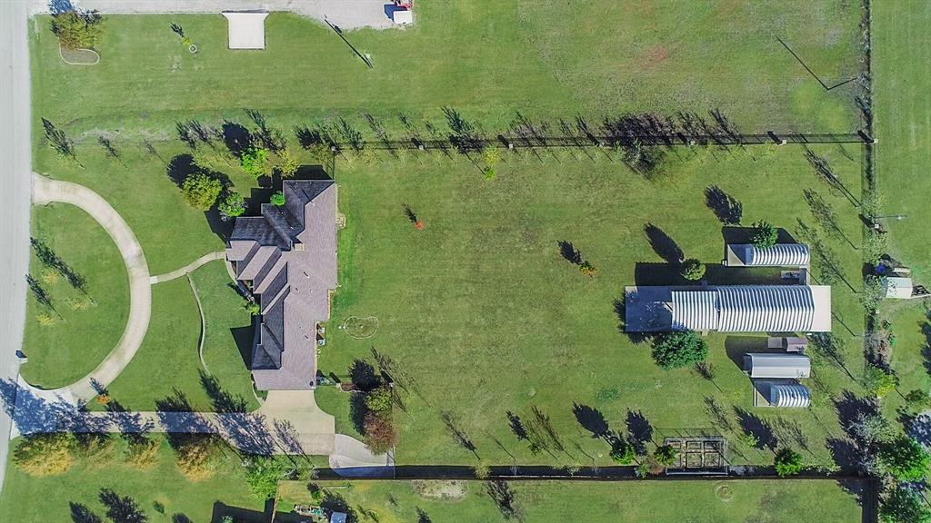 an aerial view of a house with a garden and lake view