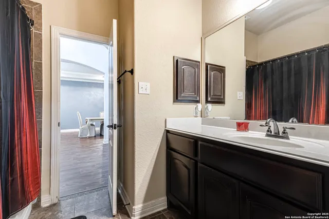 a en suite bathroom with a sink and a mirror