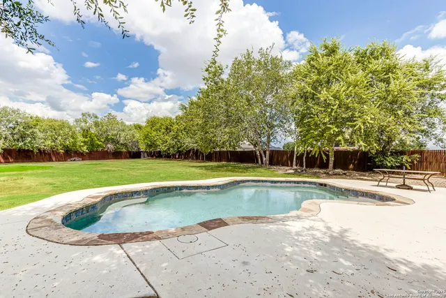 a view of a swimming pool and a yard