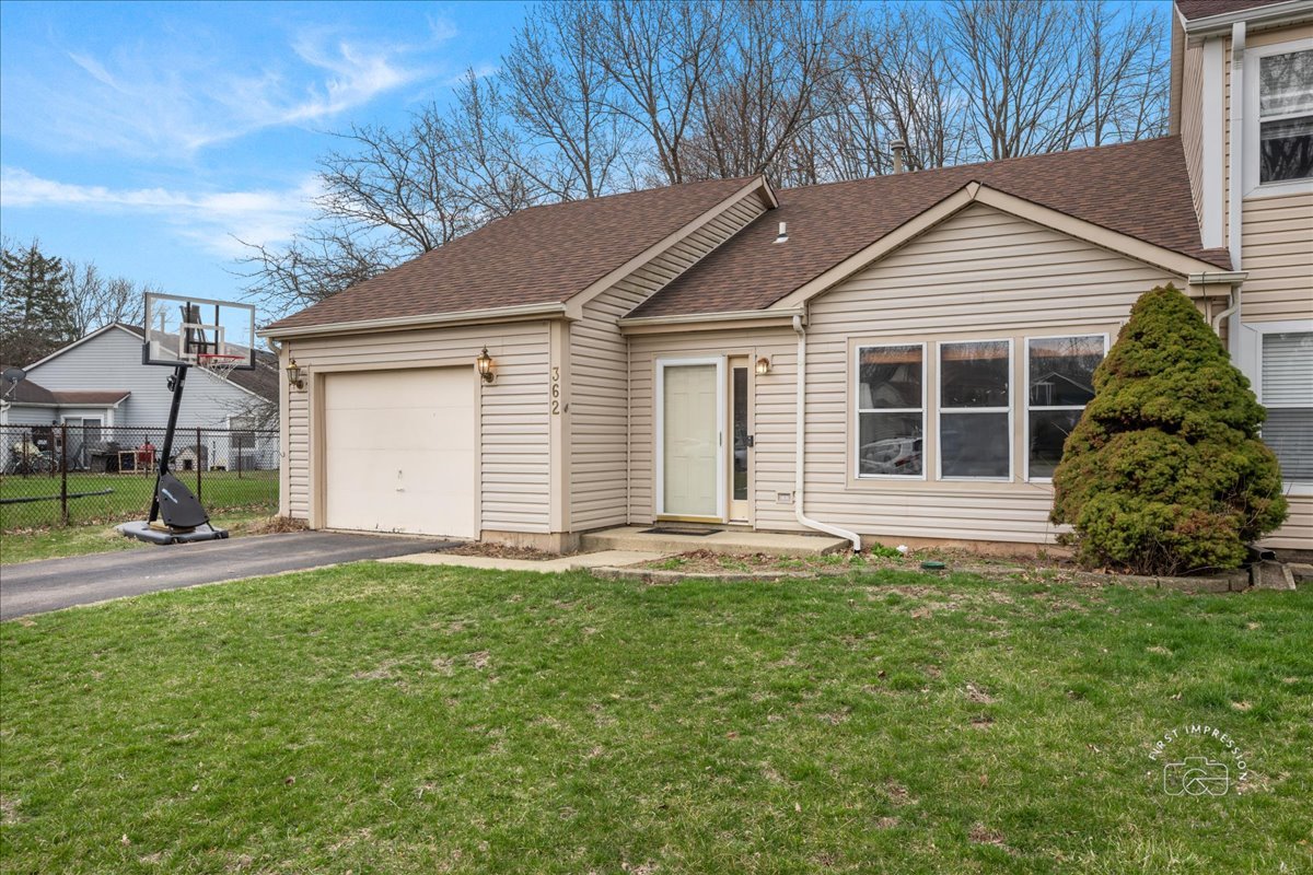 362 Chaparral Court Elgin, IL 60120 - Photo 1 of 15 a front view of a house with a yard and garage