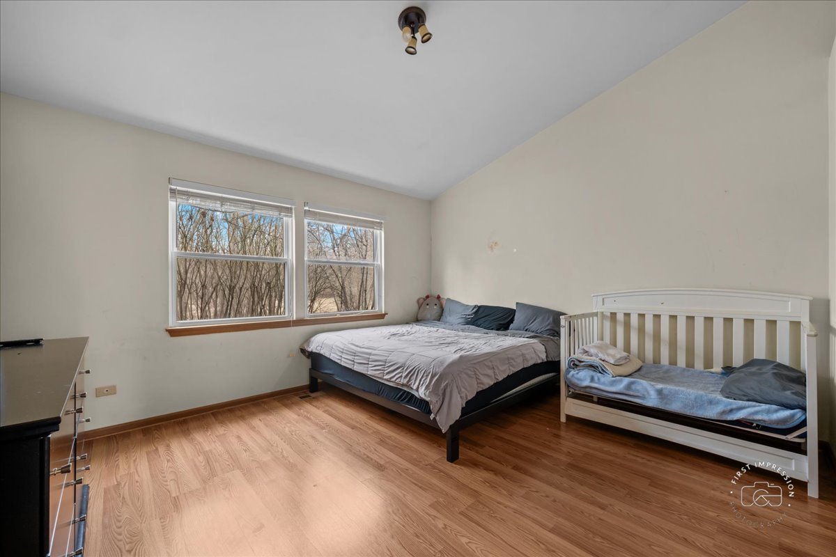 362 Chaparral Court Elgin, IL 60120 - Photo 4 of 15 a bedroom with a bed window and a window