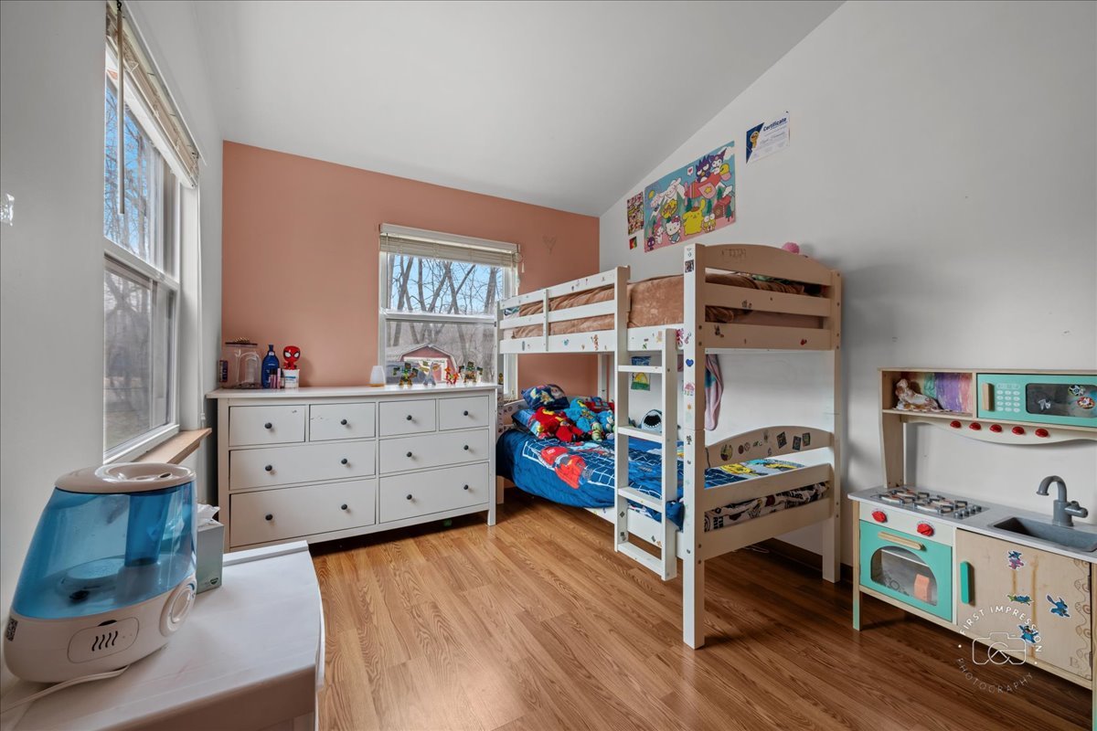 362 Chaparral Court Elgin, IL 60120 - Photo 6 of 15 a view of a bedroom with baby crib and dresser