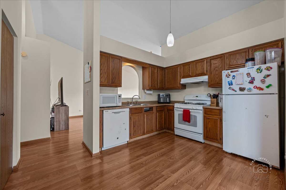 362 Chaparral Court Elgin, IL 60120 - Photo 9 of 15 a kitchen with a refrigerator and a stove top oven
