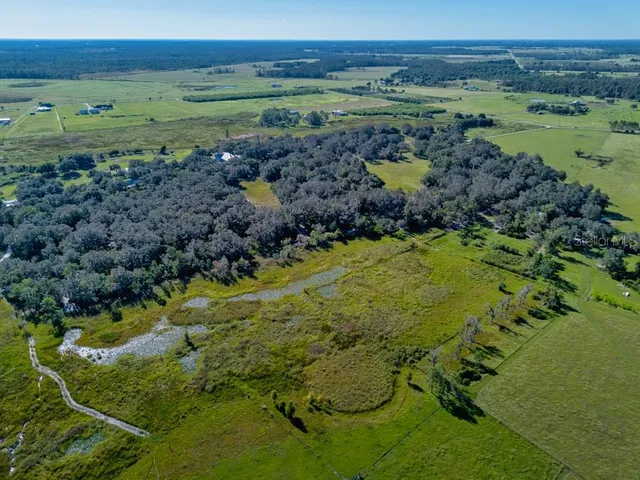 a view of a lake with a mountain and a yard
