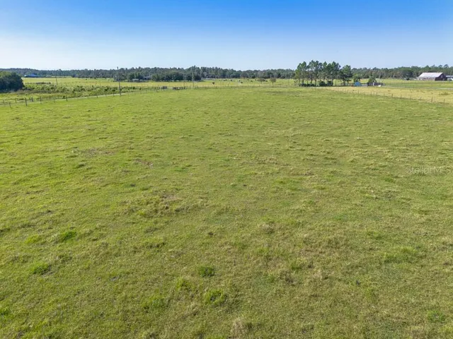a view of a field with an ocean view
