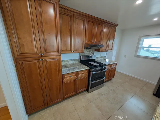 a stove top oven sitting inside of a kitchen