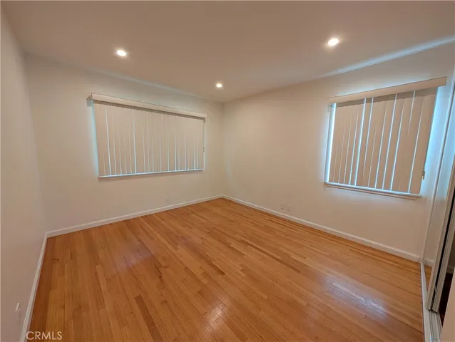 a terrace of a house with wooden floor and iron fence