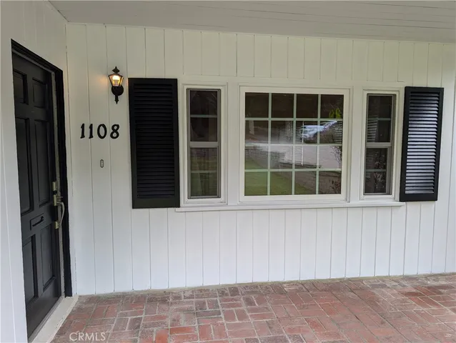 a view of empty room with wooden floor and fireplace