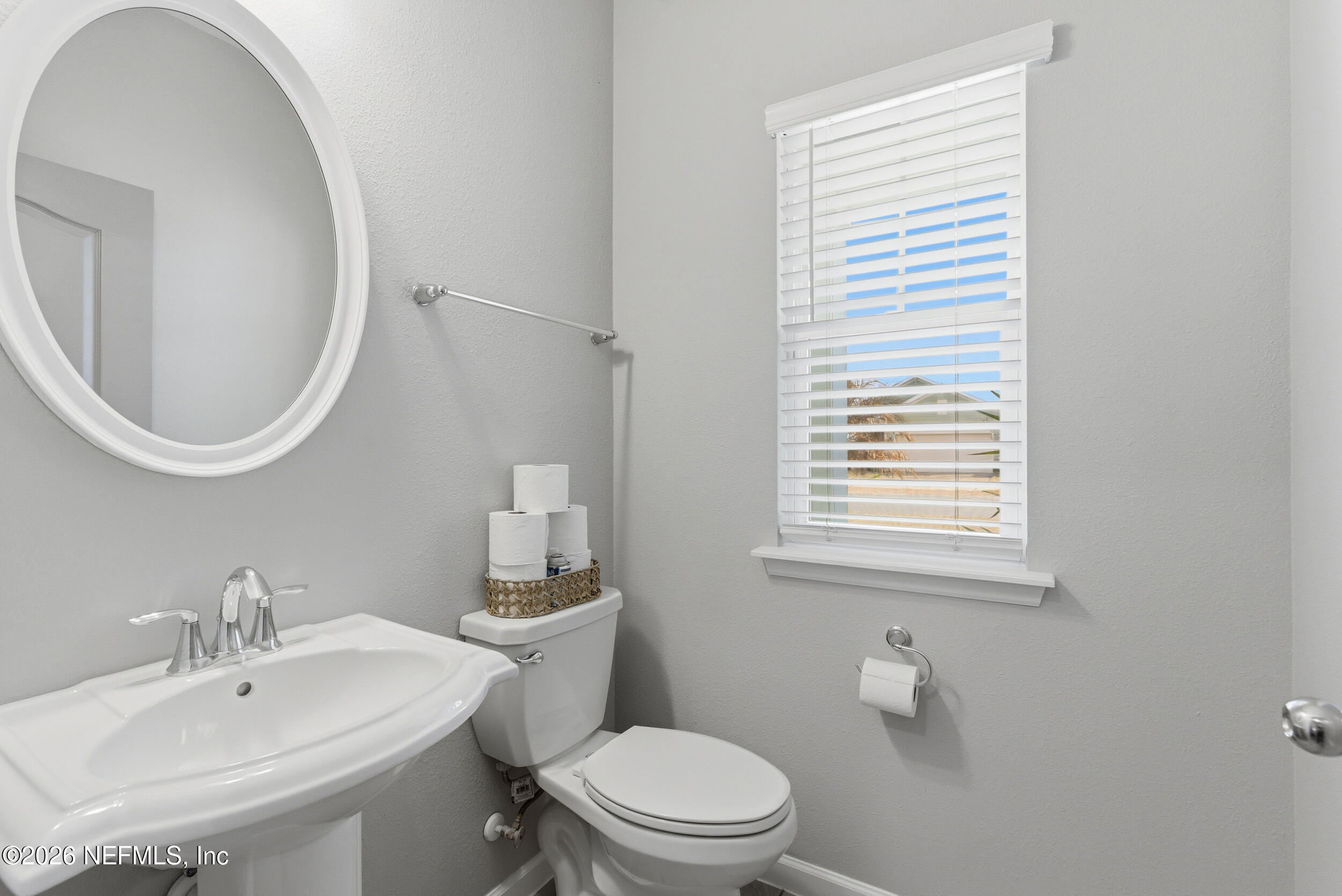 6507 Longleaf Branch Drive Jacksonville, FL 32222 - Photo 16 of 34 a bathroom with a sink a mirror and a toilet