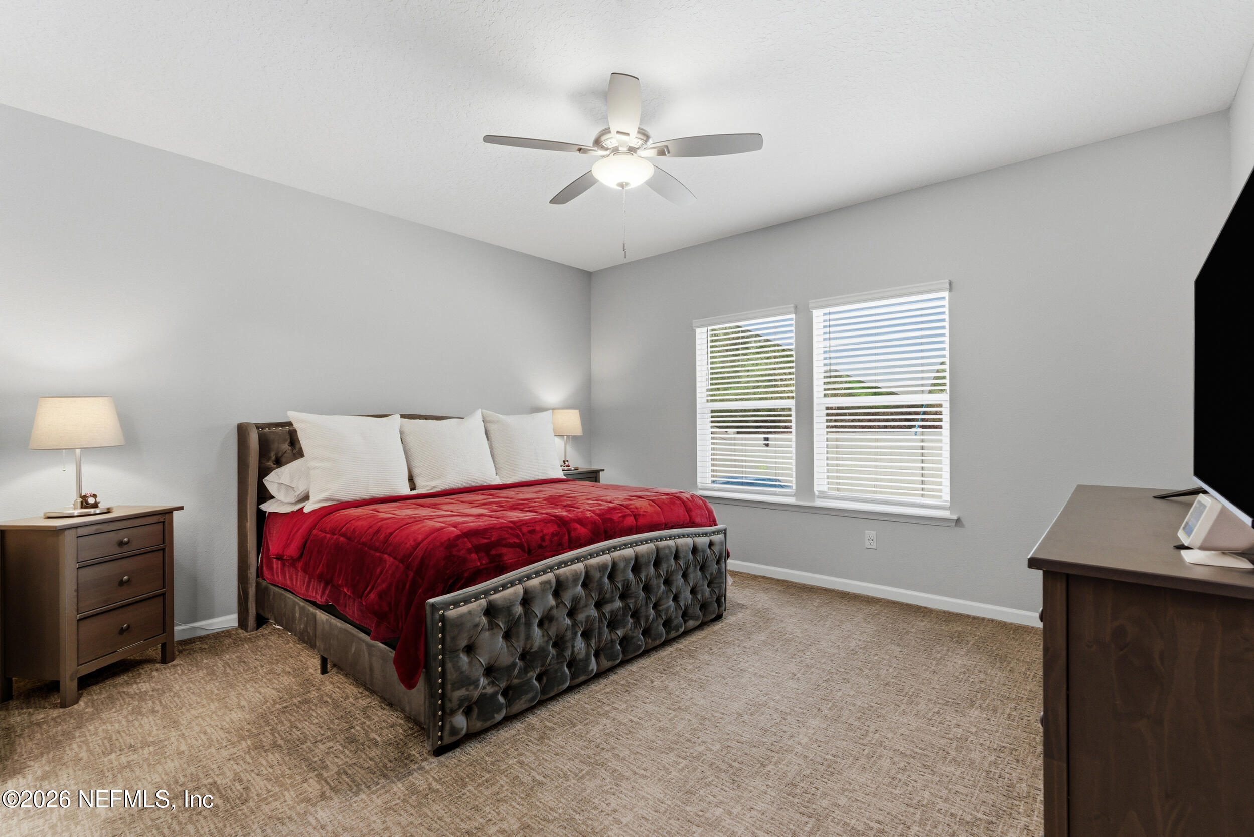6507 Longleaf Branch Drive Jacksonville, FL 32222 - Photo 18 of 34 a spacious bedroom with a bed and a flat screen tv