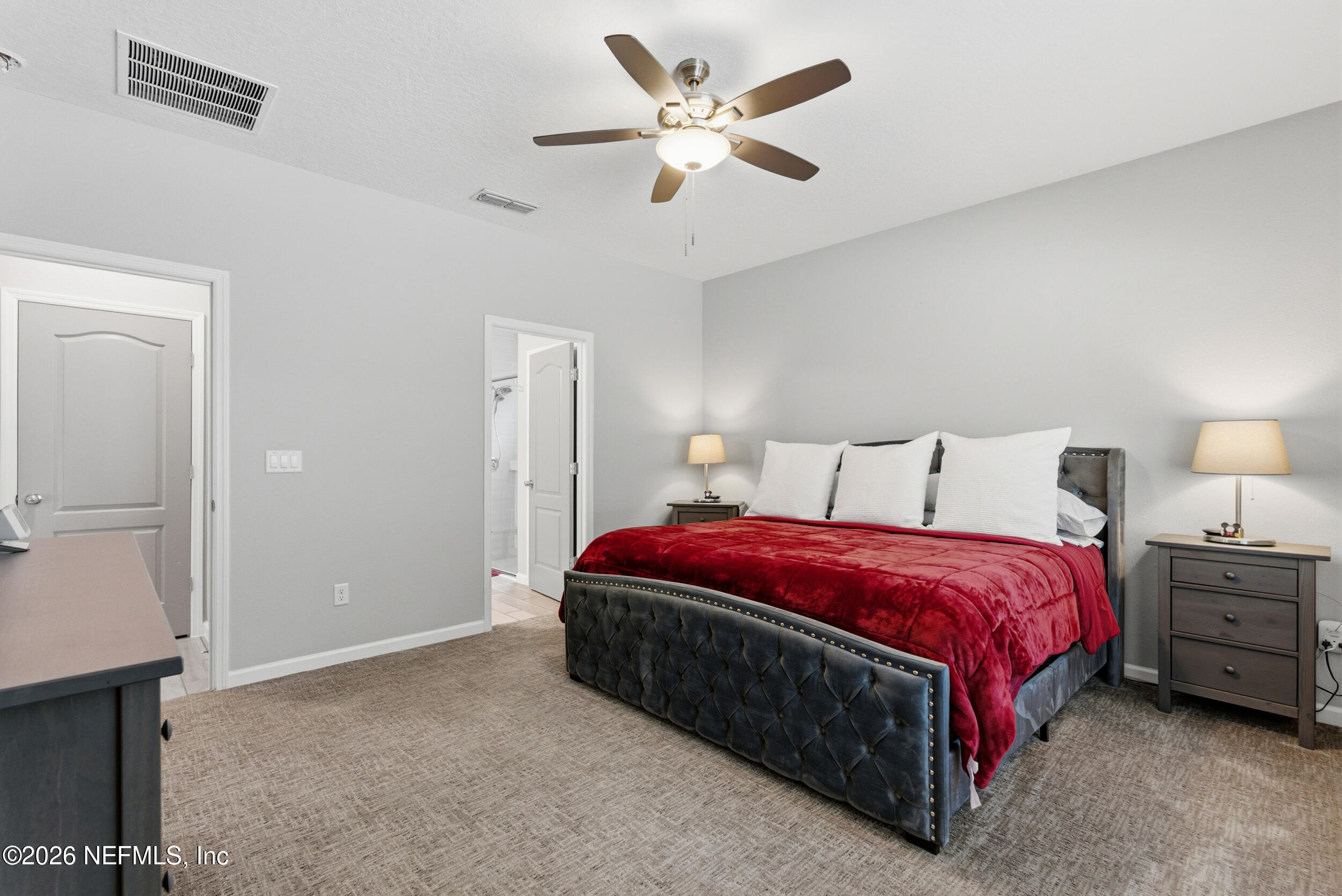 6507 Longleaf Branch Drive Jacksonville, FL 32222 - Photo 19 of 34 a spacious bedroom with a bed and a chandelier