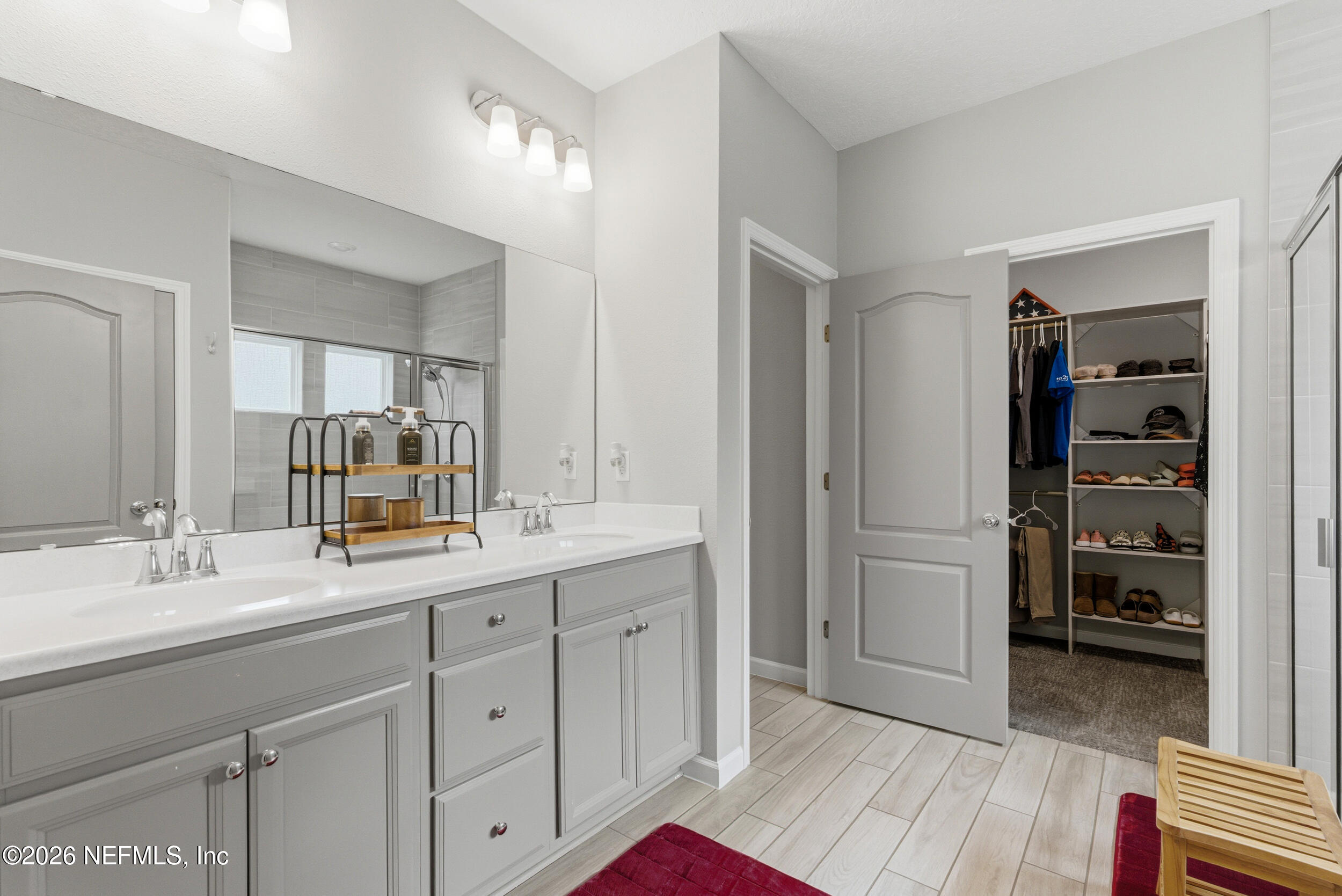 6507 Longleaf Branch Drive Jacksonville, FL 32222 - Photo 22 of 34 a en suite bathroom with a double vanity sink and a mirror