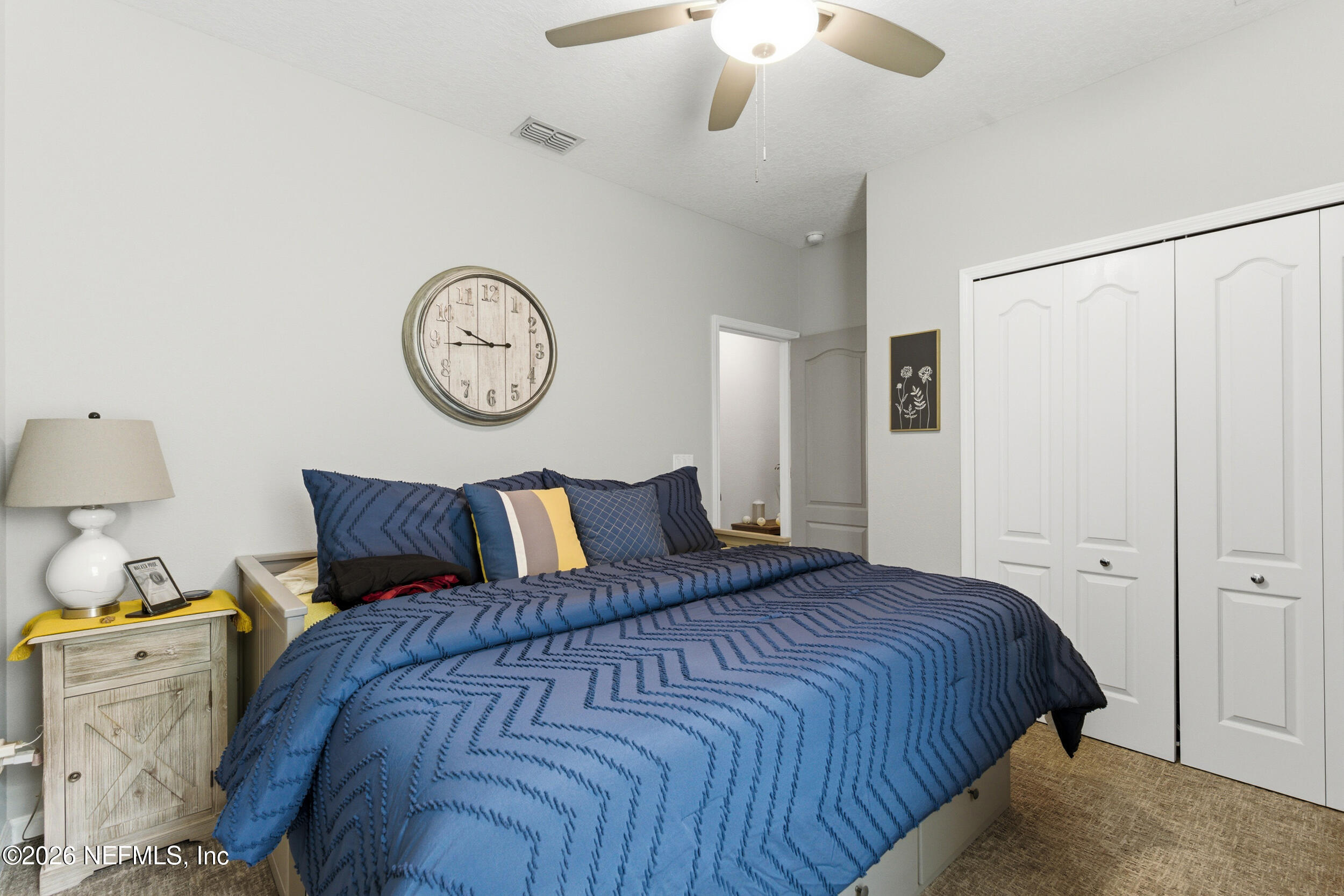 6507 Longleaf Branch Drive Jacksonville, FL 32222 - Photo 29 of 34 a bedroom with a bed and a chandelier